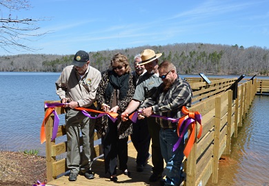 Cutting the ribbon at the new fishing pier at Croft State Parks Lake Craig were (from left) Ross Self of SCDNR, Amanda Dow and Linda Hannon of Duke Energy, Phil Gaines and John Moon of S.C. State Parks, and James Horne of Friends of Croft State Park.