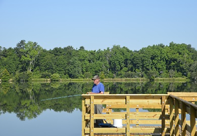 An early morning angler enjoys the new pier at Barnwell's Lake Edgar Brown. [SCDNR photo by D. Lucas]