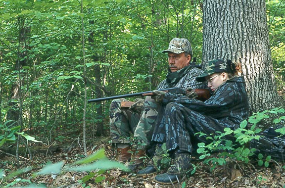 Photo of man and daughter in woods hunting