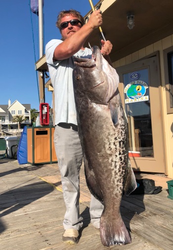 James L. Lasher, III standing with his record Gag Grouper