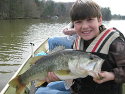 Boy holding a Large Mouth Bass
