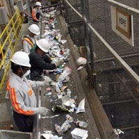 Image of workers sorting recycables. Justin Sullivan/Getty Images
