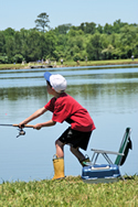 Young fisherman casting into a fishing pond at a Fishing Rodeo