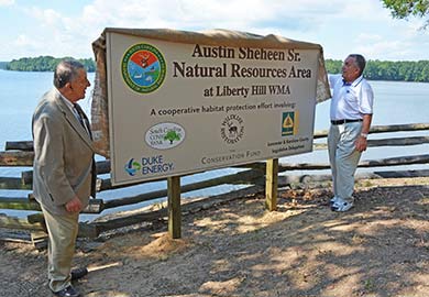 Members of the Sheheen family unveil the sign for the new land.