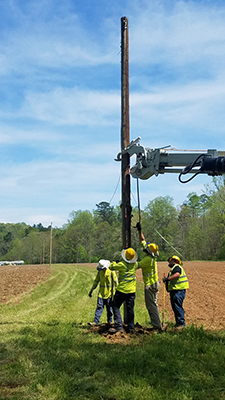 Crew erecting power-line.