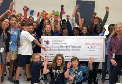 Students present check to Coastal Expeditions after raising money for the Crab Bank renourishment project. (Photo by Chris Crolley) Students present check to Coastal Expeditions after raising money for the Crab Bank renourishment project. (Photo by Chris Crolley)