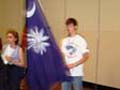 Matthew Dorn carries the state flag at the opening ceremony