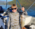 a kid holding a brown trout