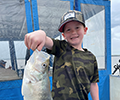 a boy holding a Crappie