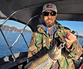 a Man holding a Brown trout