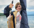 Smiling kid holding a brown trout