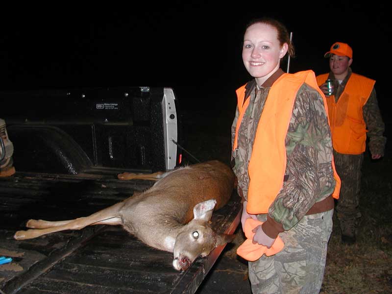 Excited youth hunter and her white-tailed deer.
