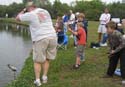 Participant helping reel fish in