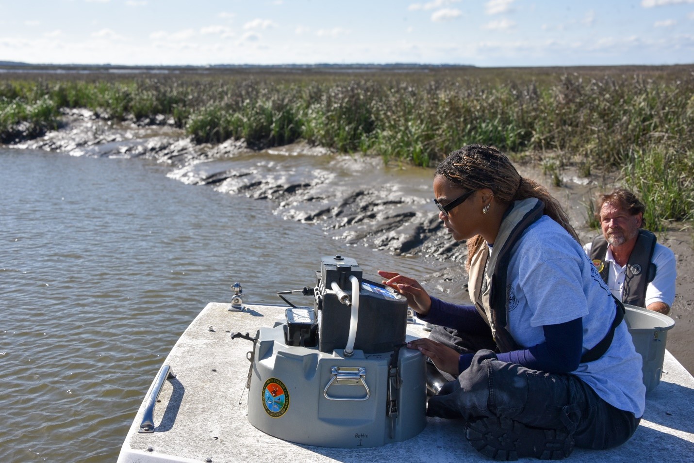 Researchers aboard a boat setting up monitoring equipment