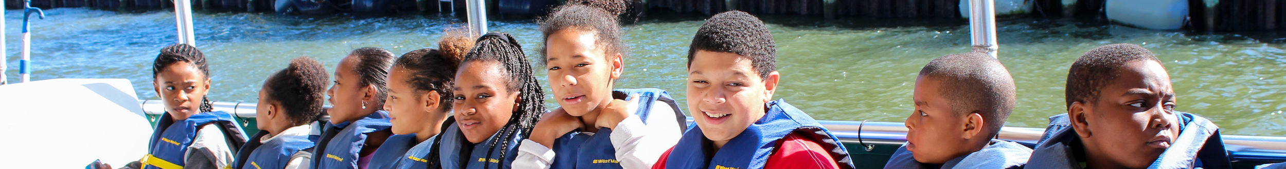 Young students aboard the E/V Discovery for an educational boat cruise