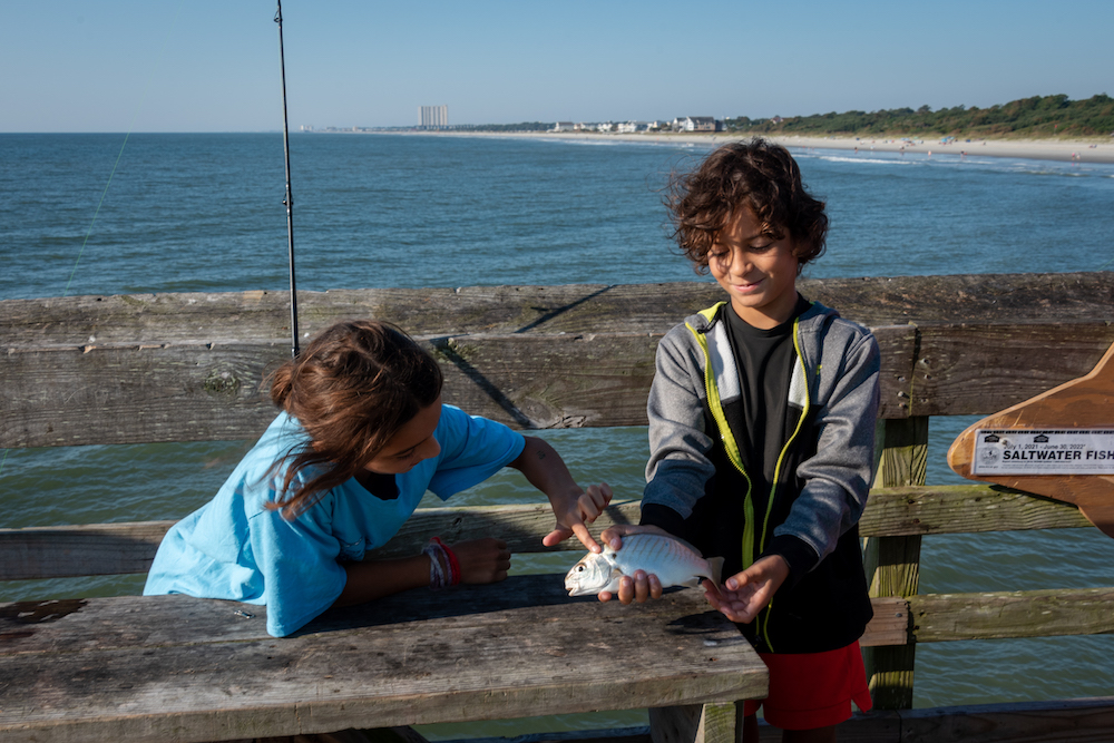 Brother and sister fishing.