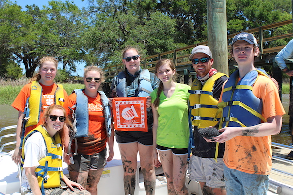 Clemson student researchers gathered around after completing work on a Living Shoreline