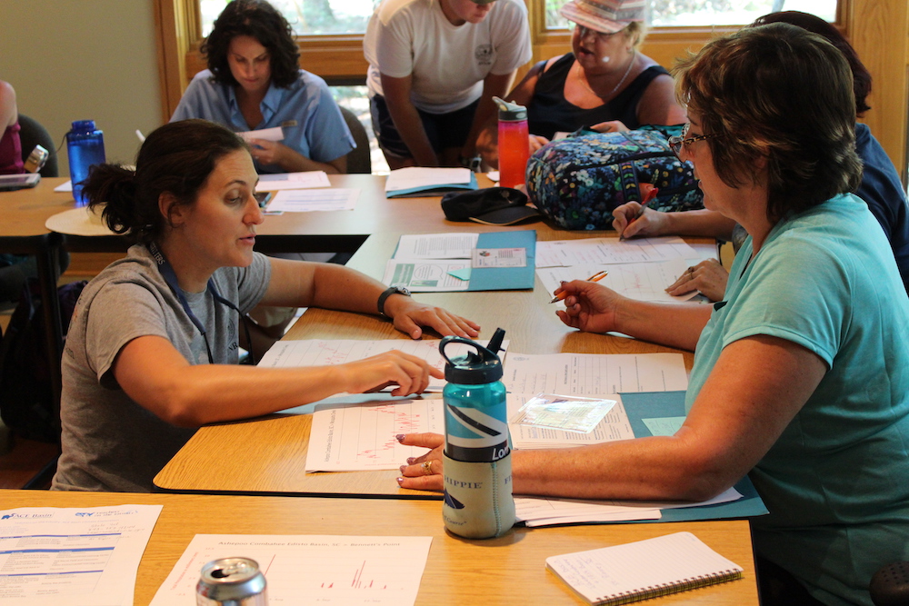 An instructor assisting a workshop participant one-on-one