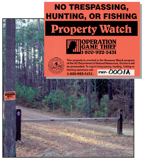 Gate at property access road, showing properly installed barriers and Property Watch sign